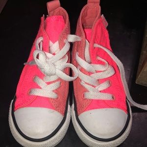 Salmon-colored hightop converse